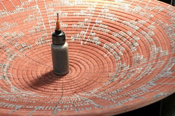 An oxide paint container sits on a piece of Rich Lopez's pottery. (Courtesy of Rich Lopez)