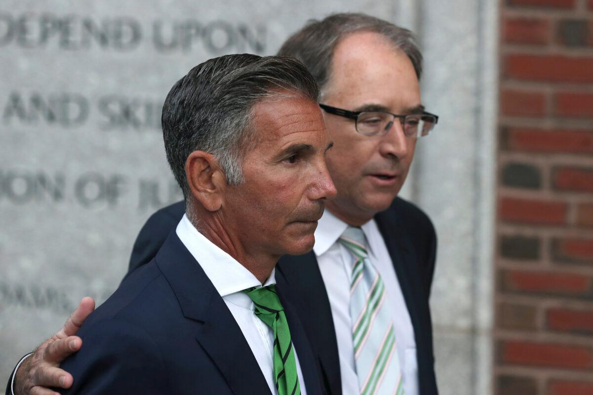 Clothing designer Mossimo Giannulli, foreground, departs federal court in Boston on April 3, 2019. (Charles Krupa/AP Photo)