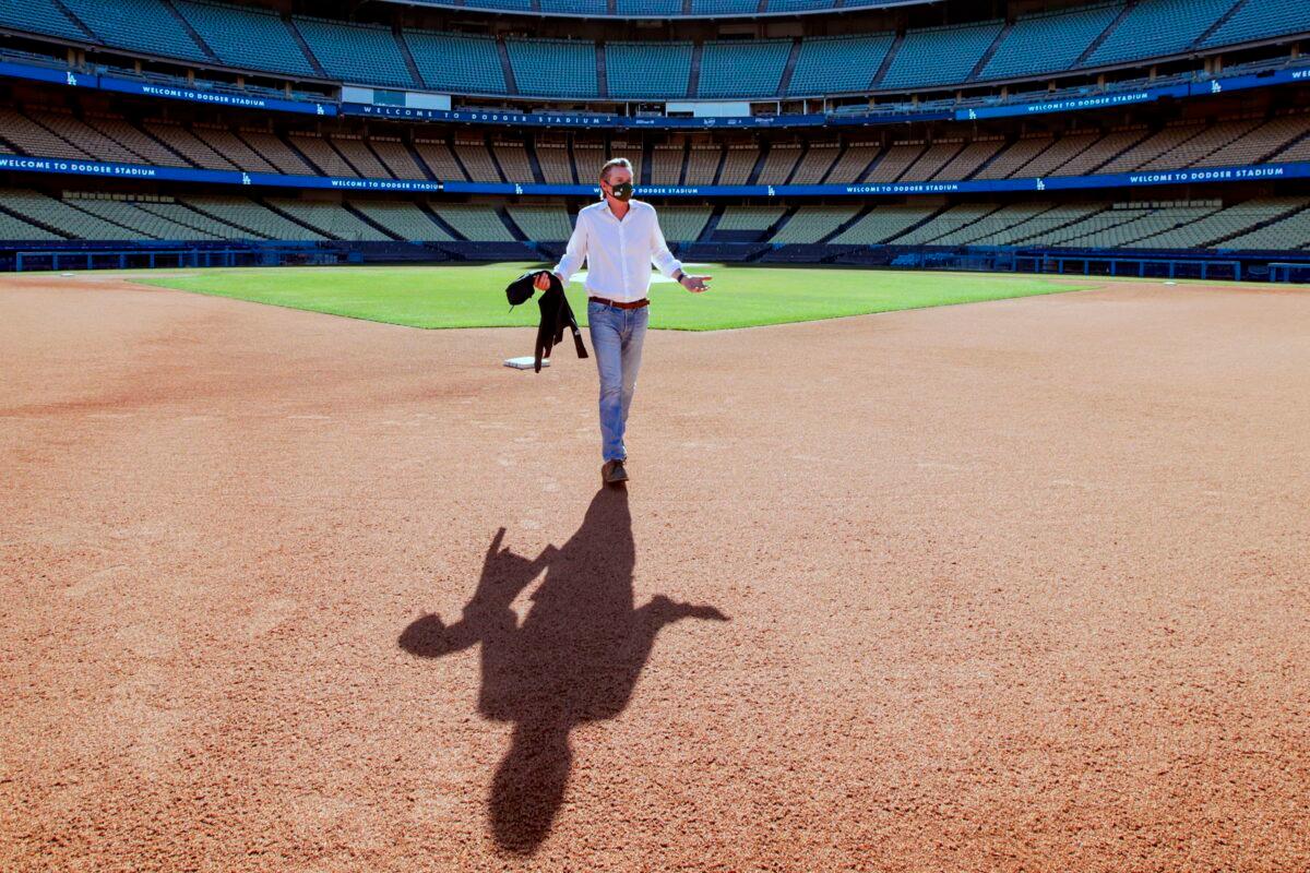 California Gov. Gavin Newsom walks to a press conference at Dodger Stadium in Los Angeles, Calif., on Jan. 15, 2021. (Irfan Khan/Pool/AFP via Getty Images)