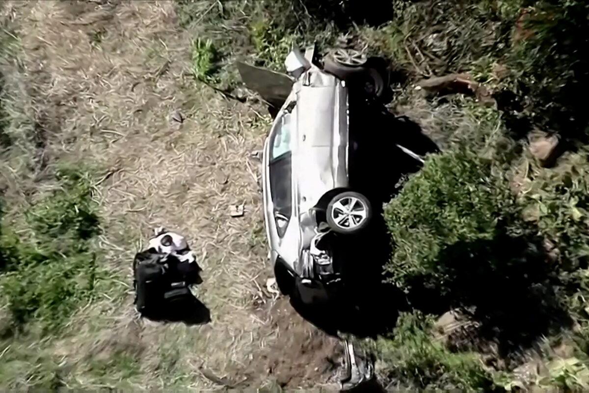 The vehicle of golfer Tiger Woods, who was rushed to hospital after suffering multiple injuries, lies on its side after being involved in a single-vehicle accident in Los Angeles, Calif., on Feb. 23, 2021. (KNBC via Reuters)