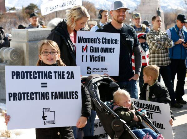 A family listens to speakers at a protest to new gun legislation at the Utah State Capitol in Salt Lake City, Utah, on Feb. 8, 2020. (George Frey//AFP via Getty Images)