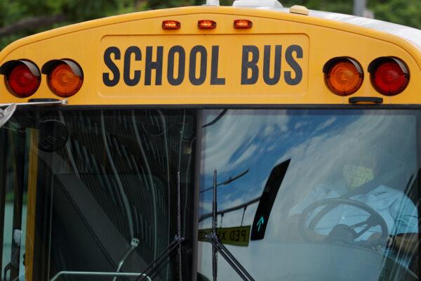 A school bus driver is seen in a caravan demanding funding from Congress for the safe reopening of schools, in Los Angeles, Calif., on Aug. 13, 2020. (Mike Blake/Reuters)