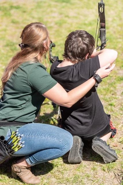 A member of Mamalitia learns to use a bow. (Courtesy of Mamalitia)