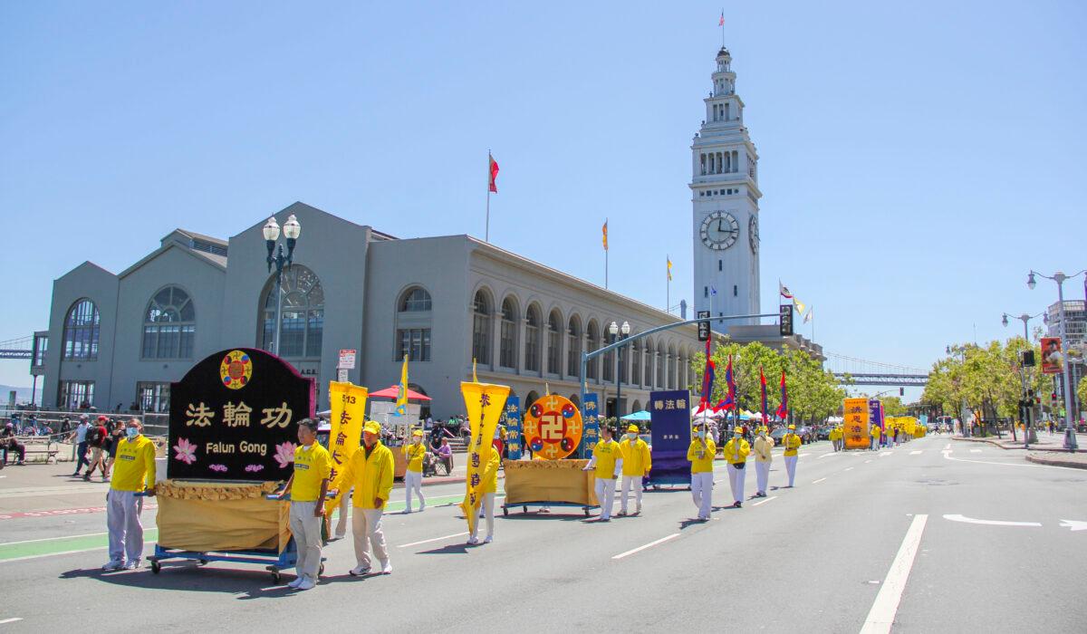 Hundreds of Falun Gong practitioners from the Bay Area participate in a parade in front of the Ferry Building to celebrate the 29th World Falun Dafa Day in San Francisco on May 8, 2021. (David Lam/The Epoch Times)