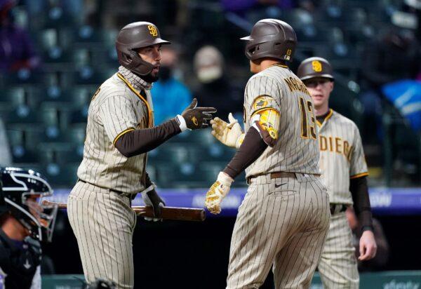 San Diego Padres' Eric Hosmer (L) congratulates Manny Machado on his two-run home run against the Colorado Rockies during the fifth inning of a baseball game in Denver, Colo., on May 11, 2021. (David Zalubowski/AP Photo)