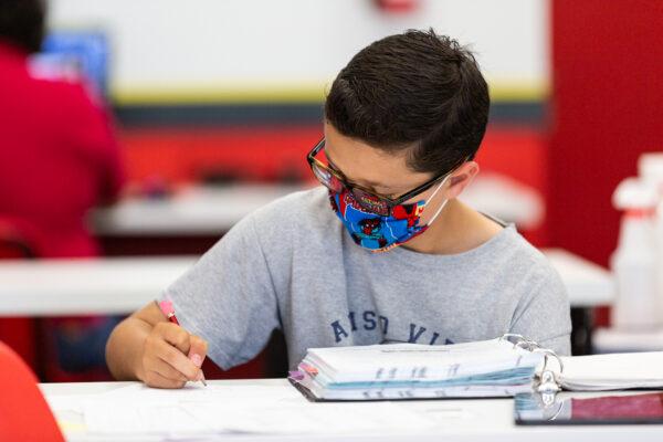 Student Nikolas Hoaen performs a math assignment at Mathnasium, in Laguna Niguel, Calif., on May 12, 2021.(John Fredricks/The Epoch Times)