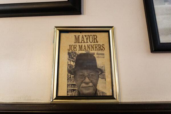 A photo of Joe Manners hangs in the Cross Eyed Cow Pizza restaurant in Oro Grande, Calif., on May 18, 2021. (John Fredricks/The Epoch Times)