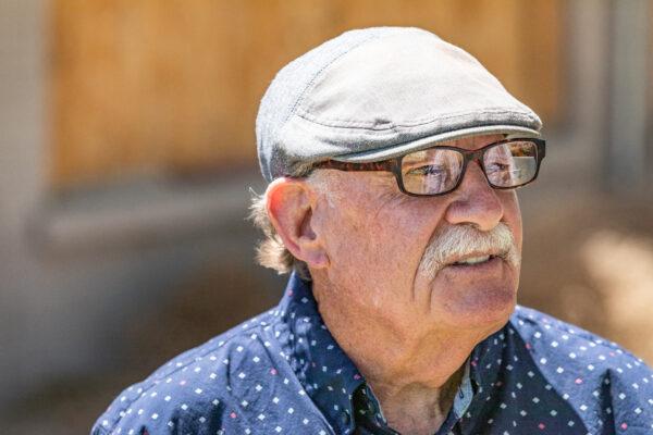 Joe Manners looks at an abandoned building in Oro Grande, Calif., on May 18, 2021. (John Fredricks/The Epoch Times)