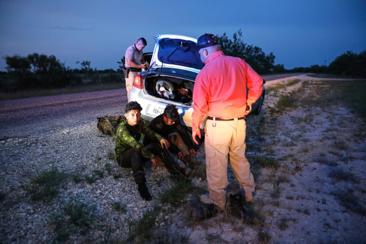 Kinney County Constable Steve Gallegos and Kinney County Sheriff’s deputies arrest a smuggler and seven illegal aliens from Guatemala near Brackettville, Texas, on May 25, 2021. (Charlotte Cuthbertson/The Epoch Times)