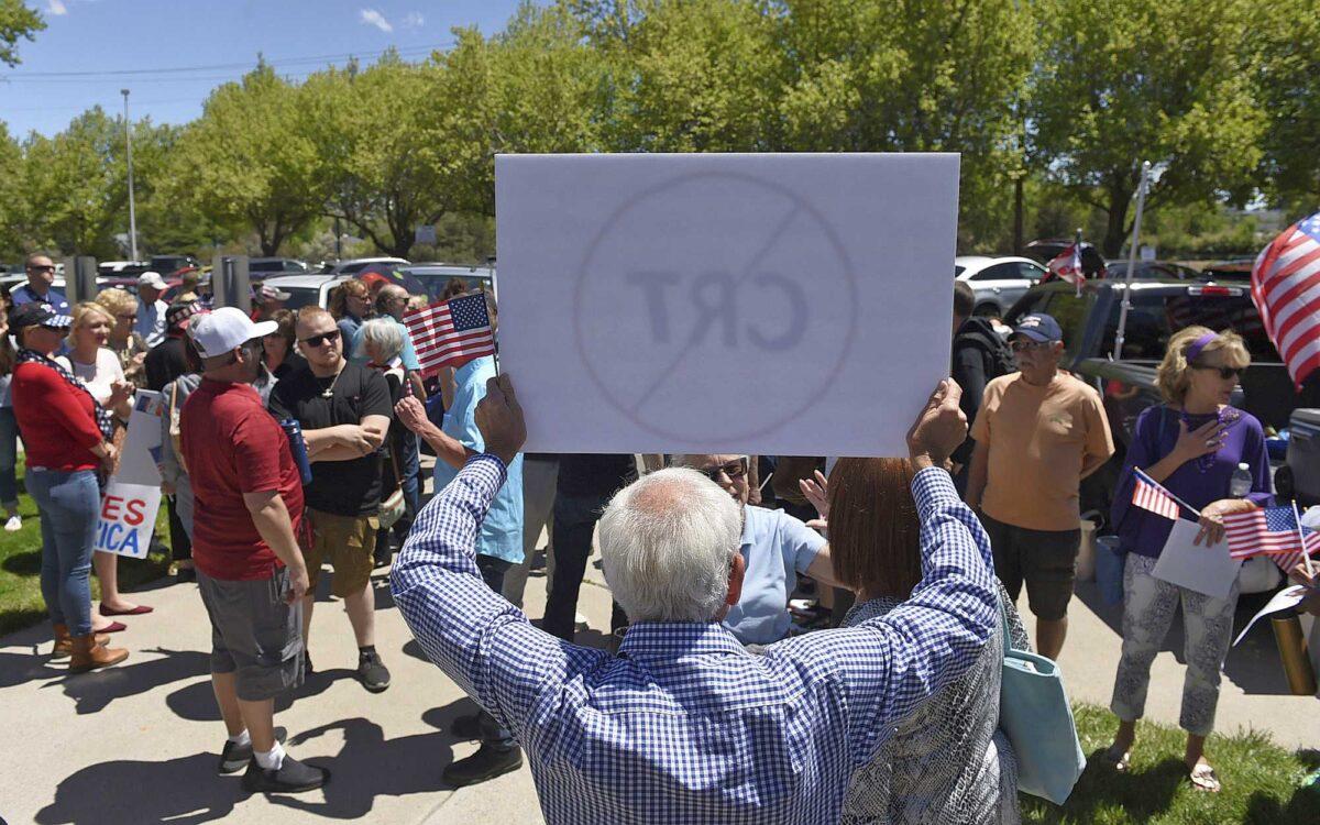 A man holds up a sign against Critical Race Theory during a protest outside a Washoe County School District board meeting in Reno, Nev., on May 25, 2021. (Andy Barron/Reno Gazette-Journal via AP)
