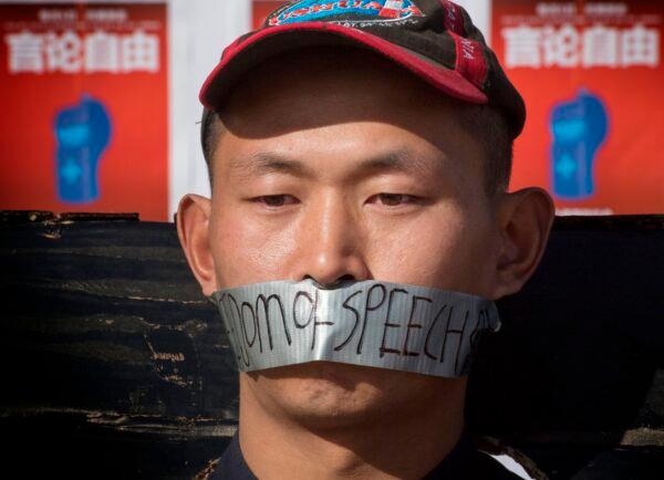 Chinese students hold a memorial for Dr. Li Wenliang, who was the whistleblower of SARS-CoV-2 that originated in Wuhan, China, outside the UCLA campus in Westwood, Calif., on Feb. 15, 2020. (Mark Ralston/AFP via Getty Images)