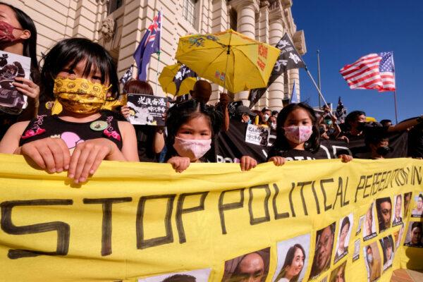 Young participants hold a banner during a "Stand With Hong Kong" rally in Pasadena, Calif., on June 12, 2021. (Ringo Chiu/AFP via Getty Images)