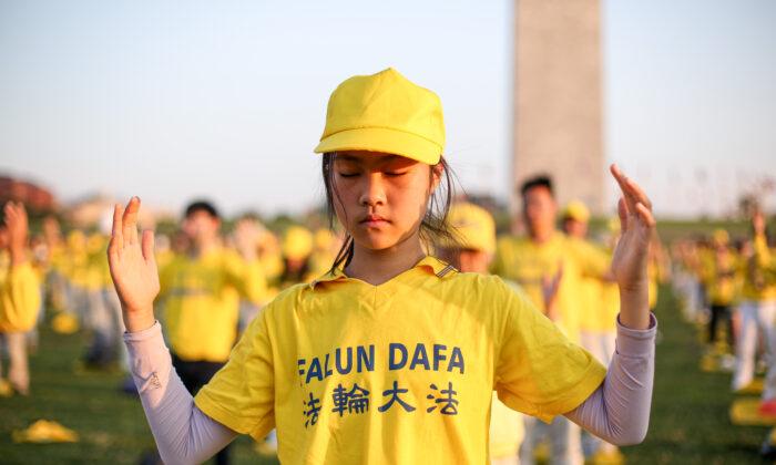 Falun Gong practitioners do exercises at an event marking the 22nd anniversary of the start of the Chinese regime’s persecution campaign against Falun Gong, in Washington on July 16, 2021. (Samira Bouaou/The Epoch Times)