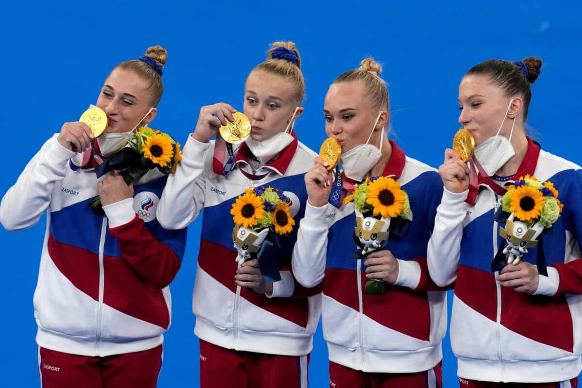 Russian Olympic Committee's artistic gymnastics women's team (L-R) Liliia Akhaimova, Viktoriia Listunova, Angelina Melnikova, and Vladislava Urazova celebrate after winning the gold medal at the 2020 Summer Olympics, in Tokyo on July 27, 2021. (Gregory Bull/AP Photo)
