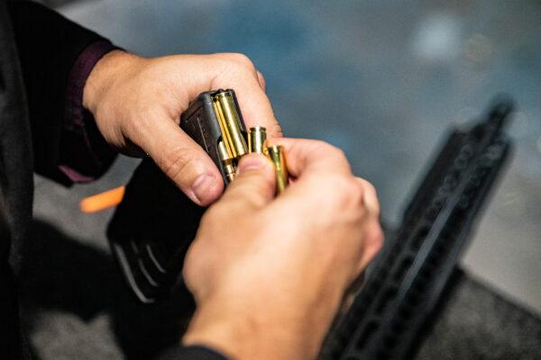 A man load .223 bullets into an AR-15 assault rifle at FT3 tactical shooting range in Stanton, Calif., on May 3, 2021. (John Fredricks/The Epoch Times)