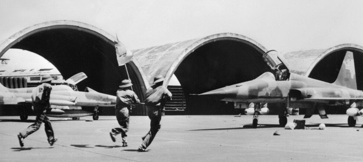 North Vietnamese troops run on the tarmac of the U.S. military airport in Tan Son Nhut, South Vietnam, on May 12, 1975. (AFP via Getty Images)