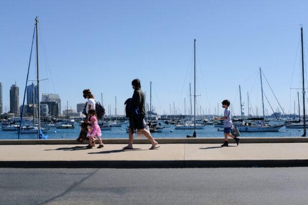 People walk along the sidewalks near the Port of San Diego, Calif., on March 27, 2021. (John Fredricks/The Epoch Times)