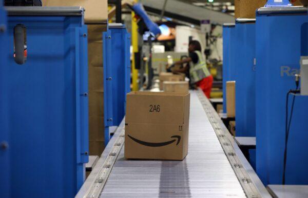 Workers fill boxes to ship at an Amazon fulfillment center in Romeoville, Ill., on Aug. 1, 2017. (Brian Cassella/Chicago Tribune/TNS)