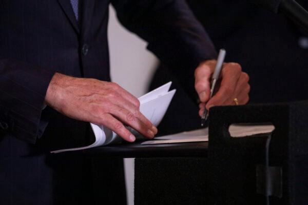 California Governor Gavin Newsom signs multiple bills in Los Angeles on Sept. 29, 2021. (John Fredricks/The Epoch Times)