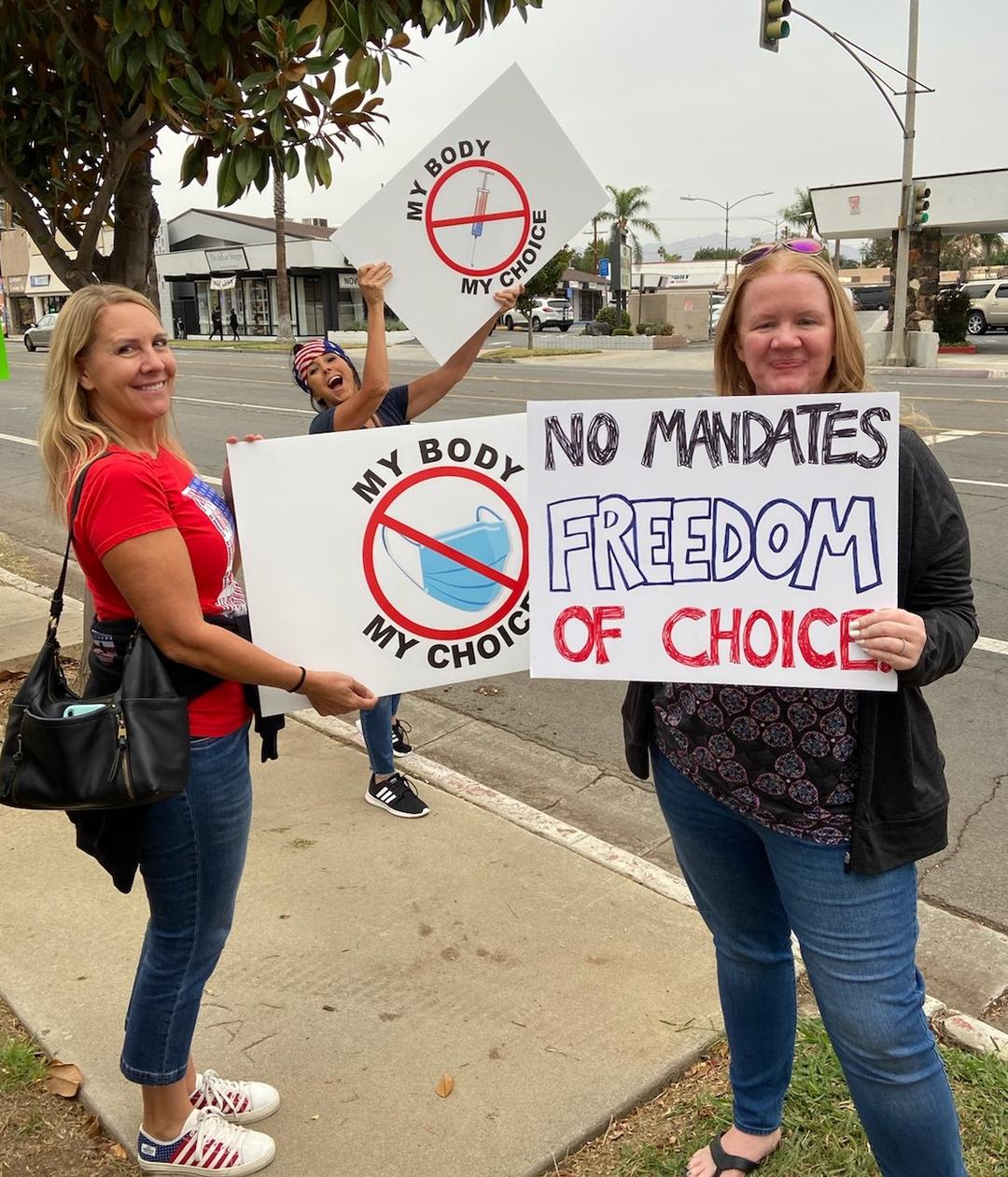 Parents and teachers hold signs in protest at Riverside Unified School District in Riverside, Calif., on Oct. 7, 2021. (Courtesy of Heather Knapp)