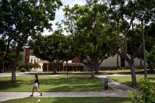 A person walks on the California State University Long Beach campus before the return of students for Fall classes in Long Beach, Calif. on Aug. 11, 2021. (Patrick T. Fallon/AFP via Getty Images)