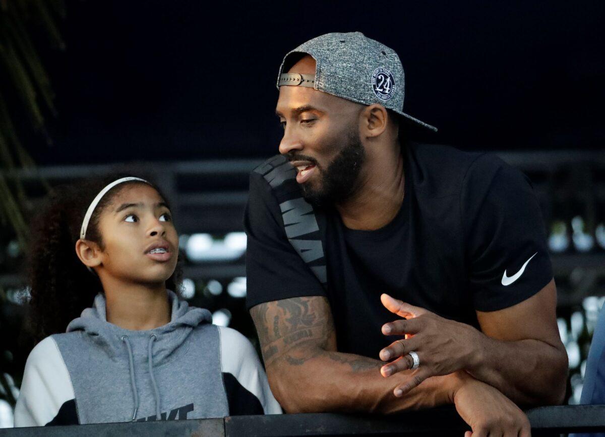 Former Los Angeles Laker Kobe Bryant and his daughter Gianna watch the U.S. national championships swimming meet in Irvine, Calif., on July 26, 2018. (Chris Carlson/AP Photo)