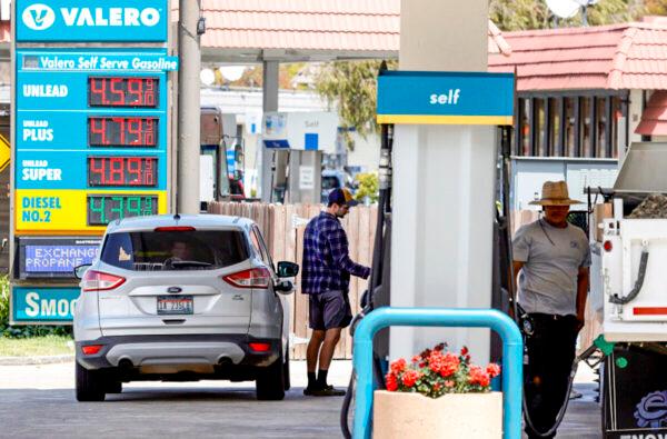 A customer prepares to pump gasoline into his car at a Valero station in Mill Valley, Calif., on July 12, 2021. (Justin Sullivan/Getty Images)