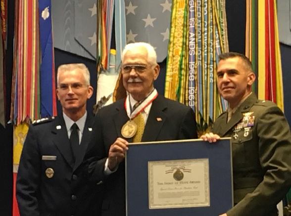 General Paul J. Selva, Vice Chairman of the Joint Chiefs of Staff, and Brigadier General Dennis A. Crall, Director, C4/Chief Information Officer of the US Marine Corps, present the Spirit of Hope award to Mr. Stone. (Cathy Jensen)