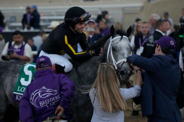 A rider celebrates after victory during the Breeders' Cup Classic race at the Del Mar racetrack in Del Mar, Calif., on Nov. 6, 2021. The owners of Del Mar Fairgrounds in San Diego County have agreed to repay the federal government for a $4.7 million COVID Paycheck Protection Program loan. (Gregory Bull/AP Photo)