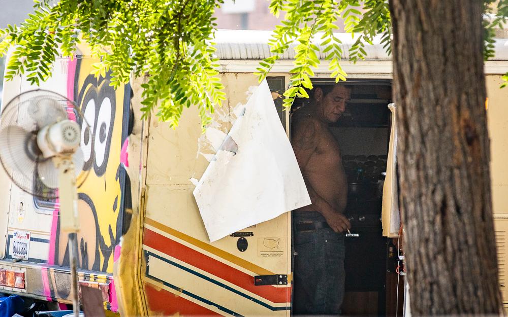 A man smokes a cigarette in a homeless RV encampment in Venice, Calif., on Nov. 10, 2021. (John Fredricks/The Epoch Times)