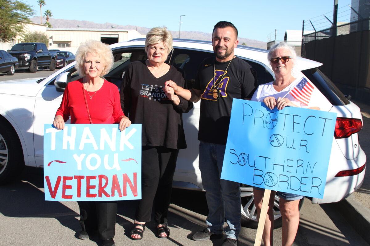 Angelica Haynes (left) and Joy Miedecke (second to left) with a Border Patrol agent and a demonstrator at a Border Patrol facility in Indio, Calif., on Nov. 11, 2021. (Brad Jones/The Epoch Times)