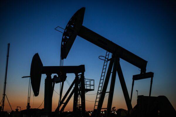 Oil pumpjacks operate at dusk Willow Springs Park in Long Beach, Calif., on April 21, 2020, a day after oil prices dropped to below zero as the oil industry suffers steep falls in benchmark crudes due to the ongoing global coronavirus pandemic. (Apu Gomes/AFP via Getty Images)