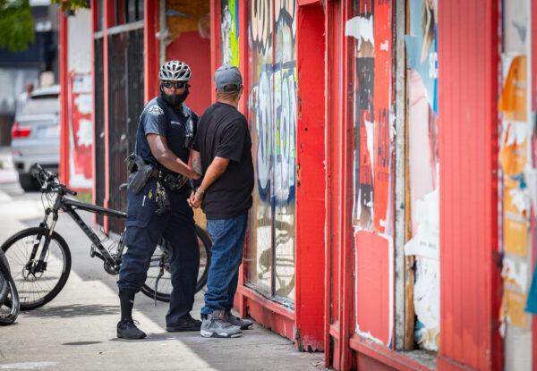 A man is arrested by a Los Angeles Police Department officer in Venice Beach, Calif., on June 2, 2020. (John Fredricks/The Epoch Times)
