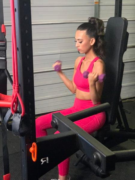 Lily Brasch, who has centronuclear myopathy, a rare form of muscular dystrophy, lifts weights to gain strength despite her body's weakness. (Courtesy of Born To Prove)