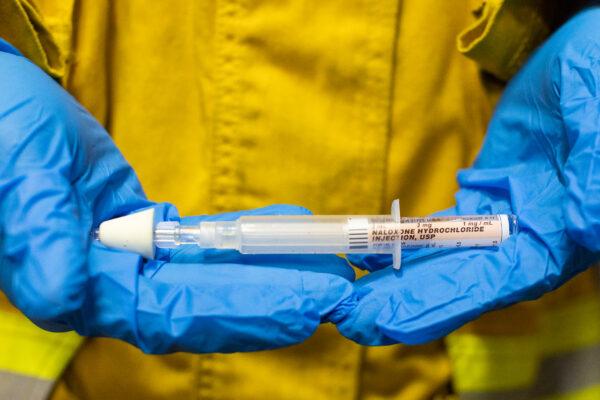 A firefighter displays Naloxone, a lifesaving medication used to reverse opioid overdoses, on Feb. 26, 2021. (John Fredricks/The Epoch Times)