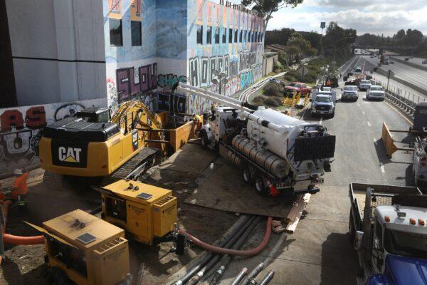 Sanitation engineers work at the site of a leak in Carson, Calif., on Dec. 31, 2021. (David Swanson/Reuters)