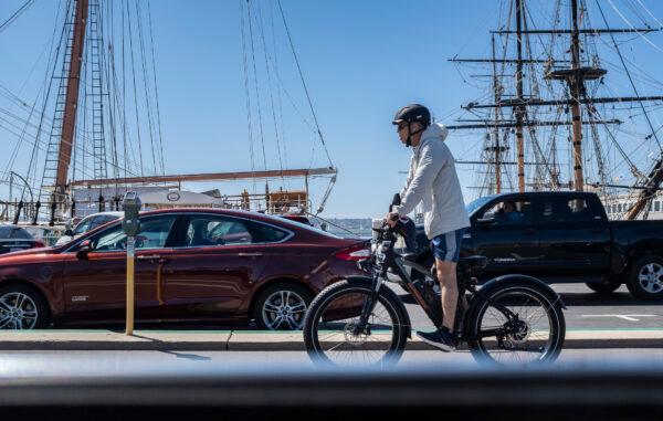 A man rides an e-bike in San Diego on March 27, 2021. (John Fredricks/The Epoch Times)