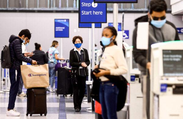 People gather in the United Airlines departures area at Los Angeles International Airport (LAX) in Los Angeles, Calif., on Dec. 1, 2021. (Mario Tama/Getty Images)