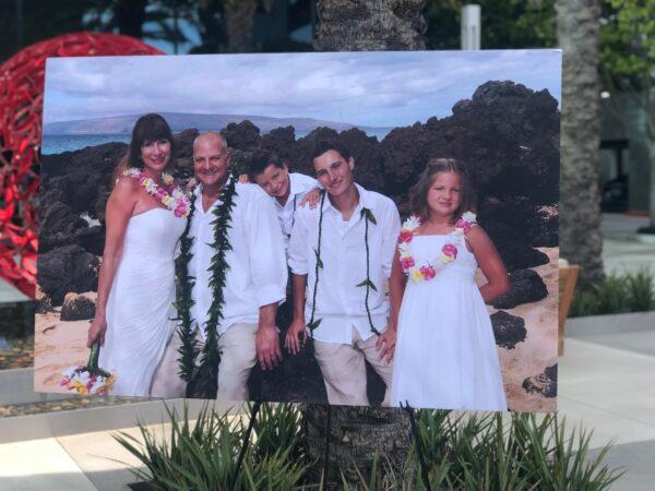 A family picture of Nerissa Regnier (L), who died of COVID-19, is shown during a press conference in Irvine, Calif., on Jan. 26, 2022. (Brandon Drey/The Epoch Times)