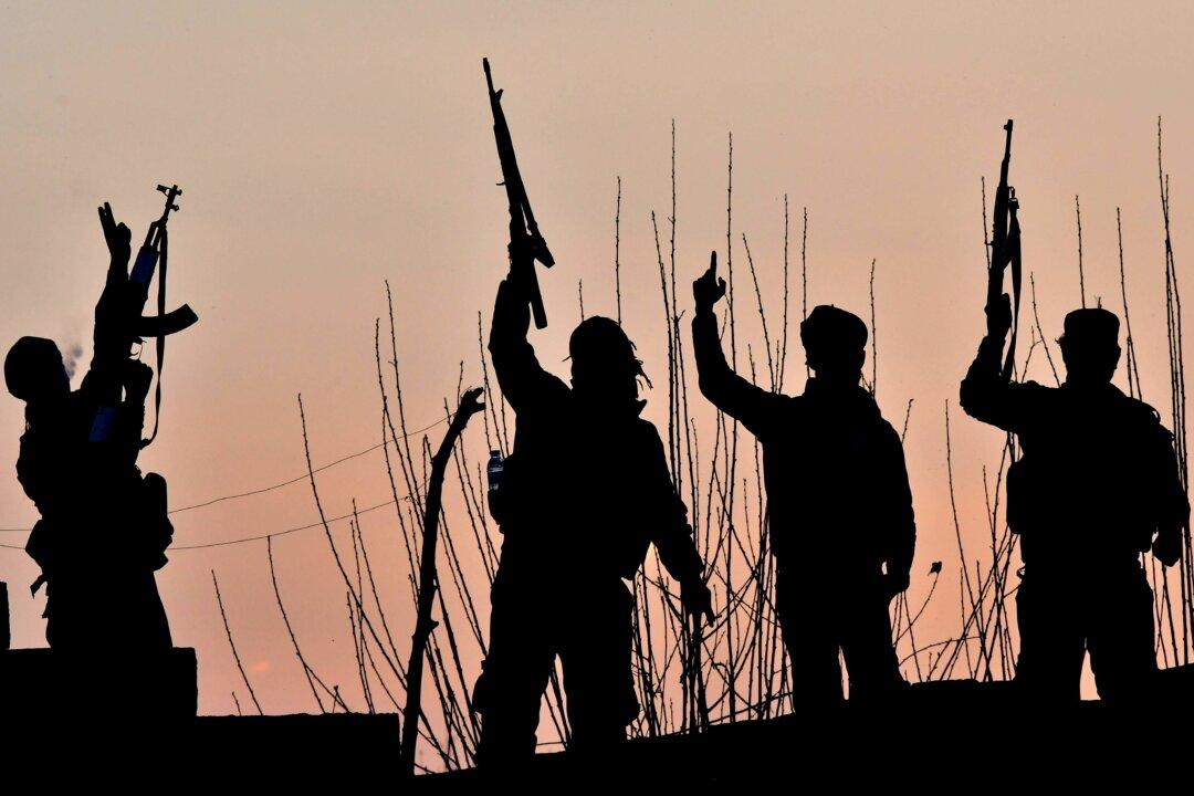 U.S.-backed Syrian Democratic Forces (SDF) fighters celebrate after fighting the ISIS terrorist group near the village of Baghouz, Syria, on March 15, 2019. The increase in brutal attacks on Christian communities by radicalized insurgents in recent years both parallels and intersects a broader rise in violent Islamist extremism worldwide and especially in West Africa. (Giuseppe Cacace/AFP via Getty Images)