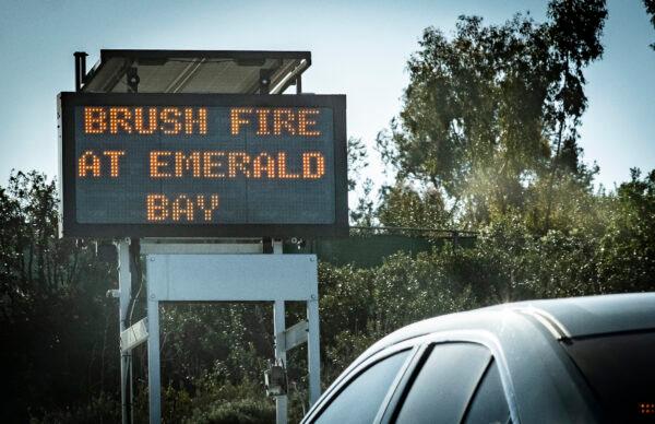 First responders work together in extinguishing the flames of a wildfire near the Irvine Cove neighborhood in Laguna Beach, Calif., on Feb. 10, 2022. (John Fredricks/The Epoch Times)