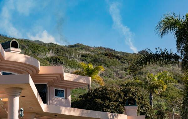 First responders work together in extinguising the flames of a wildfire buring in Laguna Beach, Calif., on Feb. 10, 2022. (John Fredricks/The Epoch Times)