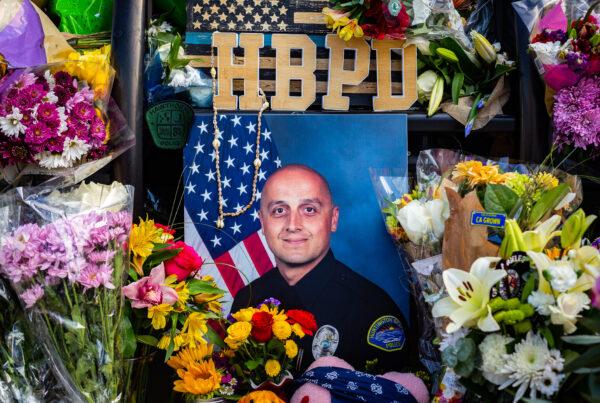A memorial of flowers for the passing of Huntington Beach Police Officer Nicholas Vella is displayed near the Huntington Beach Police station in Huntington Beach, Calif., on Feb. 22, 2022. (John Fredricks/The Epoch Times)