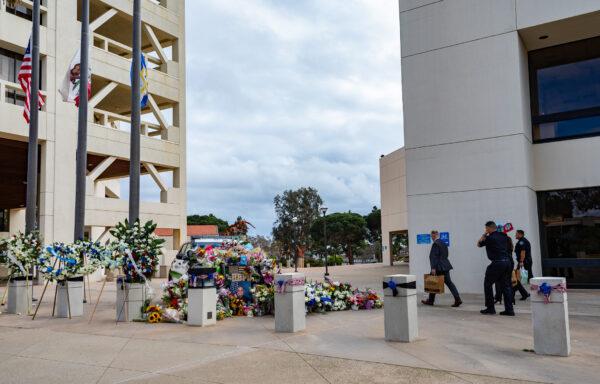 A growing memorial of flowers for the passing of Huntington Beach Police Officer Nicholas Vella is displayed near the Huntington Beach Police station in Huntington Beach, Calif., on Feb. 22, 2022. (John Fredricks/The Epoch Times)