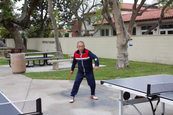 Manh Nguyen plays ping pong with his cardiologist Dr. Michael Chan in Orange, Calif., on March 31, 2022. (Drew Van Voorhis/The Epoch Times)