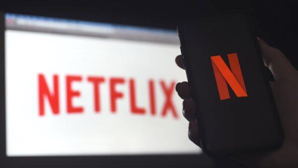 In this photo illustration a computer and a mobile phone screen display the Netflix logo in Arlington, Va., on March 31, 2020. (Olivier Douliery/AFP via Getty Images)