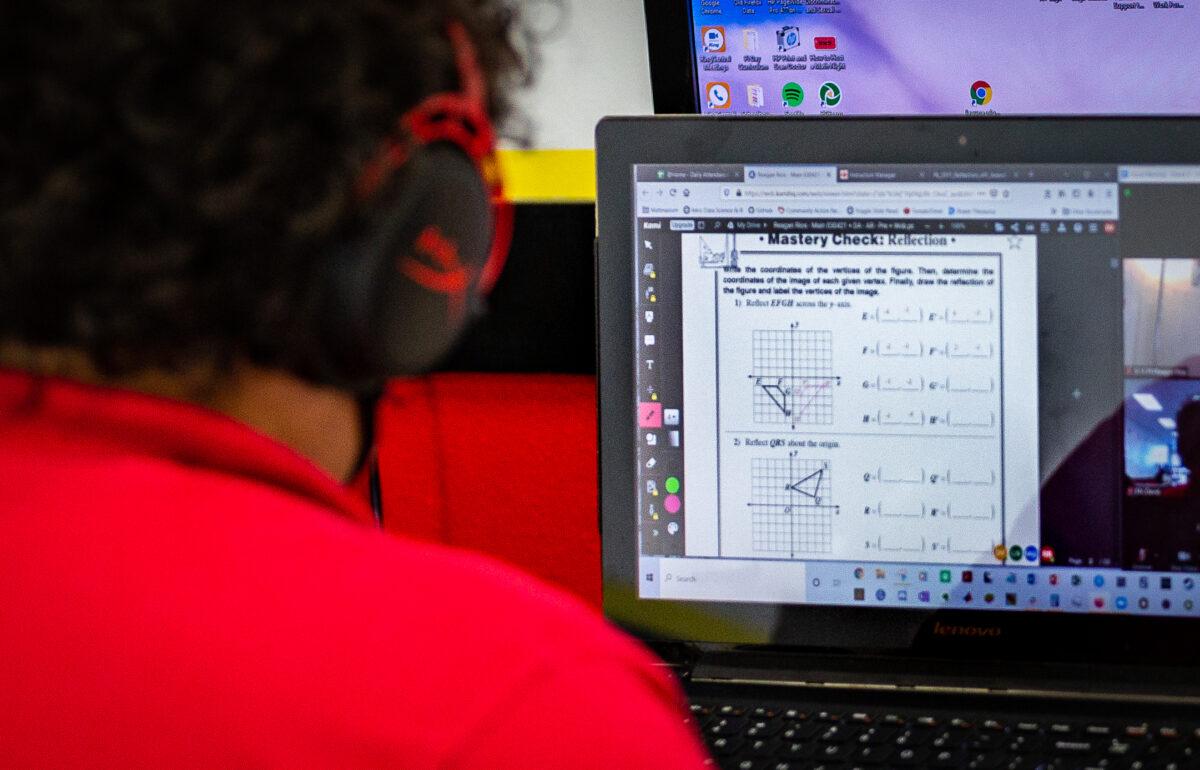 A child works with a math tutor in Laguna Niguel, Calif., on May 12, 2021. (John Fredricks/The Epoch Times)