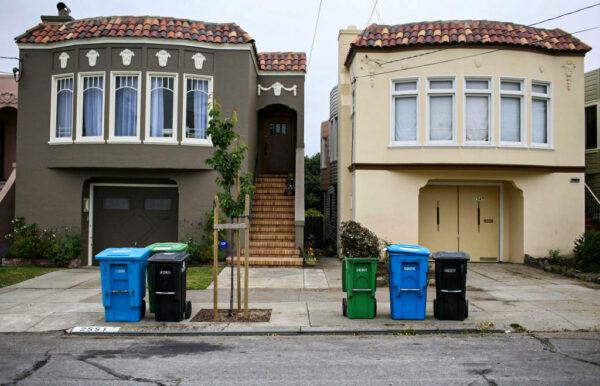 Trash, recycling, and compostable material bins sit in front of homes in a Sunset district neighborhood in San Francisco, Calif., on June 11, 2009. (Justin Sullivan/Getty Images)
