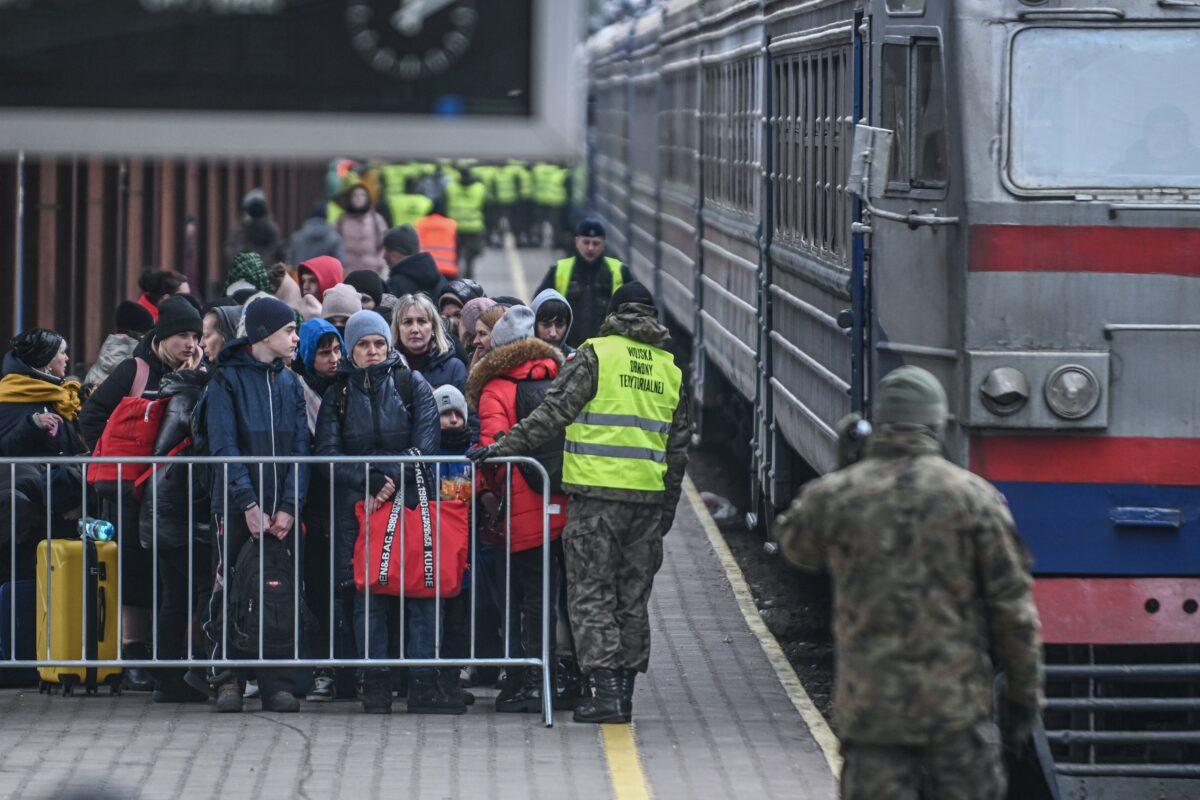 Refugees wait in line to cross passport control as they arrive on a train from Lviv in Przemysl, Poland, on March 4, 2022. (Omar Marques/Getty Images)