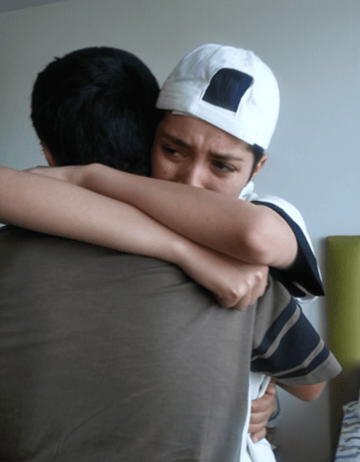 Yaeli Martinez (R) hugs her younger brother on her 17th birthday at the group home in Los Angeles when Martinez surprised her and brought Yaeli's brother and sisters to visit. (Courtesy of Abigail Martinez)